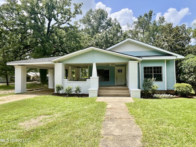 708 Lee Ave, Crystal Springs, MS 39059 - view of front facade featuring a porch, a front yard, and a carport