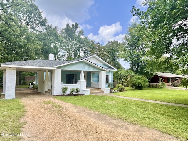 708 Lee Ave, Crystal Springs, MS 39059 - view of front of property with driveway, covered porch, an attached carport, a chimney, and a front yard