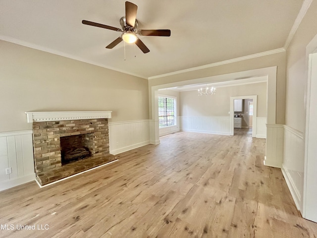 708 Lee Ave, Crystal Springs, MS 39059 - unfurnished living room featuring ornamental molding, a chandelier, a ceiling fan, a wainscoted wall, and wood finished floors