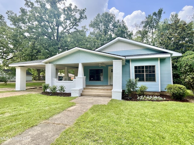 708 Lee Ave, Crystal Springs, MS 39059 - view of front of property featuring a porch, a front lawn, a ceiling fan, and a carport