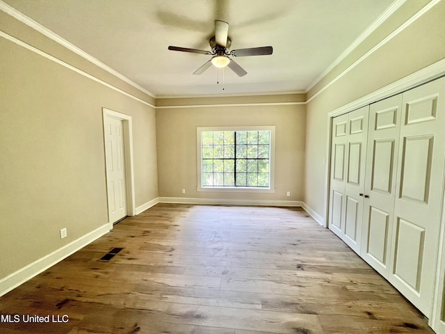 708 Lee Ave, Crystal Springs, MS 39059 - unfurnished bedroom featuring ornamental molding, wood finished floors, a closet, and ceiling fan