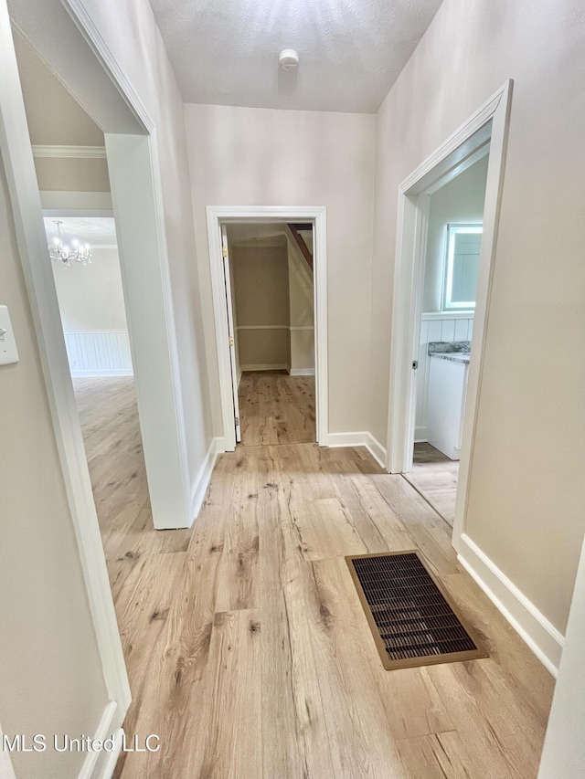 708 Lee Ave, Crystal Springs, MS 39059 - corridor with wood finished floors and a chandelier