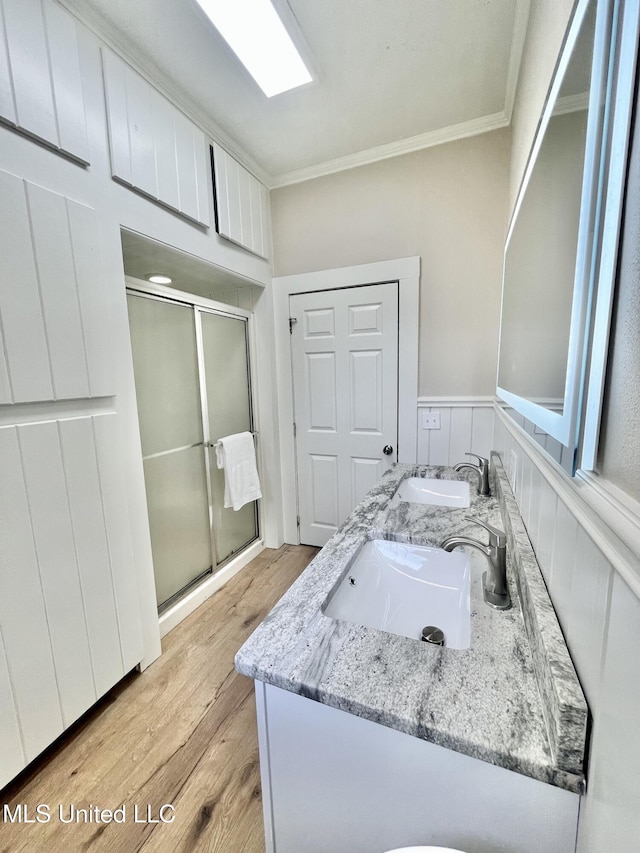 708 Lee Ave, Crystal Springs, MS 39059 - bathroom with ornamental molding, a shower stall, wood finished floors, and double vanity