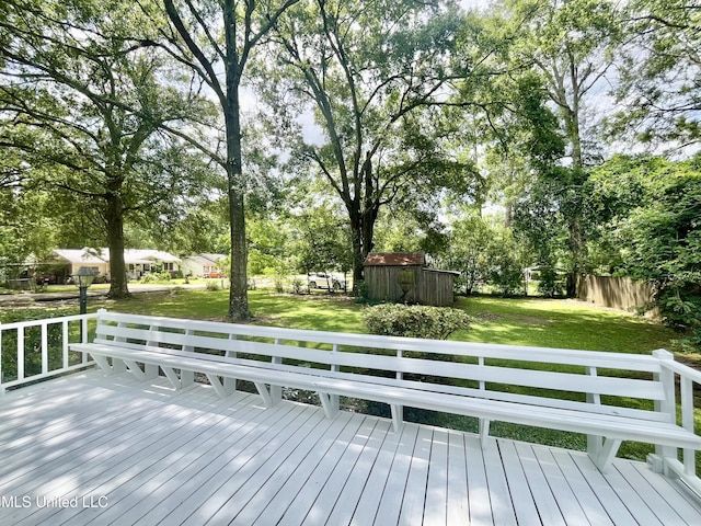 708 Lee Ave, Crystal Springs, MS 39059 - wooden terrace with a shed, a yard, and view of wooded area