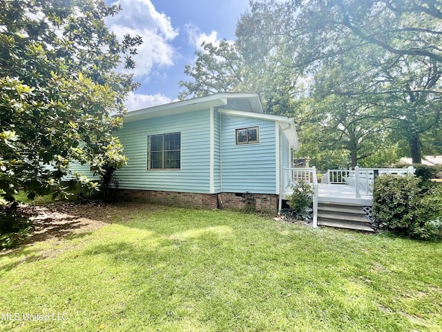 708 Lee Ave, Crystal Springs, MS 39059 - view of property exterior featuring a wooden deck, a lawn, and crawl space