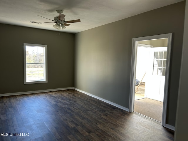 empty room featuring dark hardwood / wood-style floors and ceiling fan