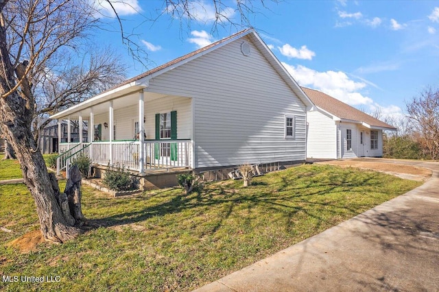 view of property exterior featuring a yard and covered porch