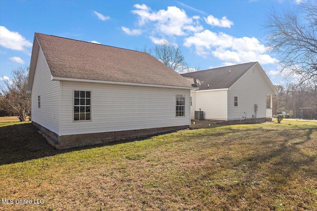 back of property featuring central AC unit and a lawn