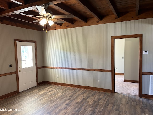 spare room featuring beam ceiling, dark hardwood / wood-style floors, ceiling fan, and wood ceiling