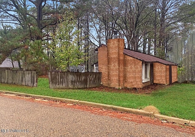 view of home's exterior featuring a lawn