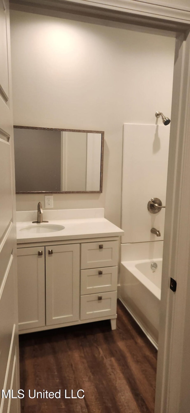 233 Allstate Dr, Jackson, MS 39211 - bathroom with wood finished floors, vanity, and washtub / shower combination