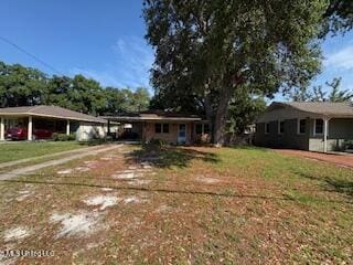 2314 Curcor Dr, Gulfport, MS 39507 - ranch-style home featuring an attached carport, a front yard, and driveway