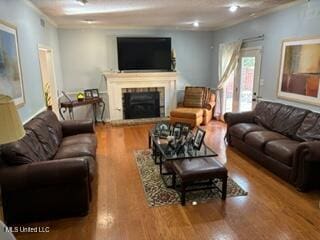 living room featuring ornamental molding and hardwood / wood-style floors