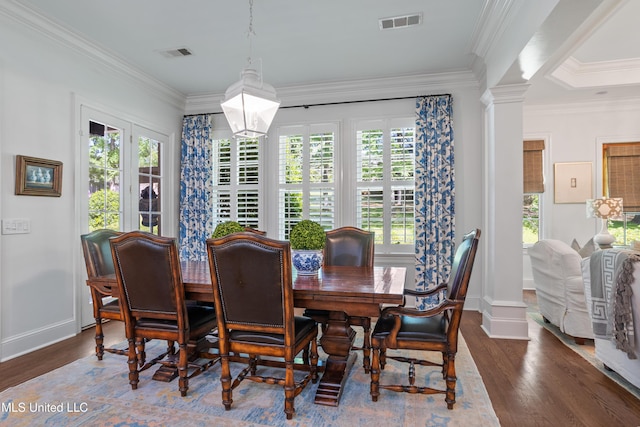 dining area with visible vents, a wealth of natural light, and wood finished floors