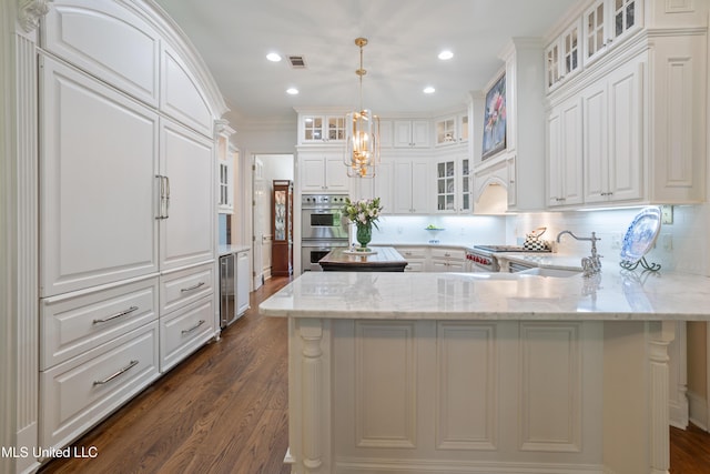 kitchen featuring decorative backsplash, a peninsula, wine cooler, double oven, and dark wood-style floors