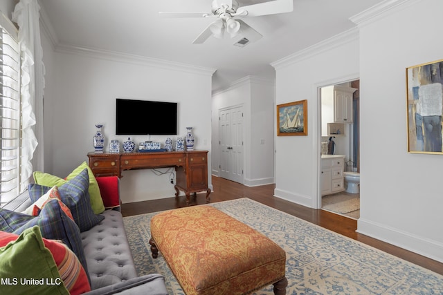 bedroom with ornamental molding, multiple windows, wood finished floors, and visible vents