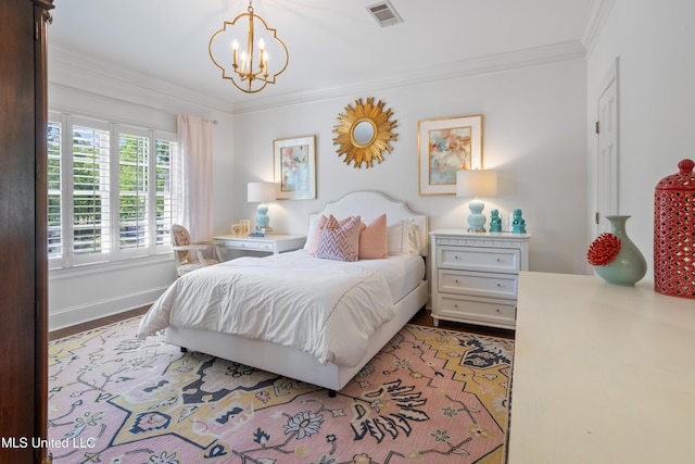 bedroom with wood finished floors, ornamental molding, a chandelier, and visible vents
