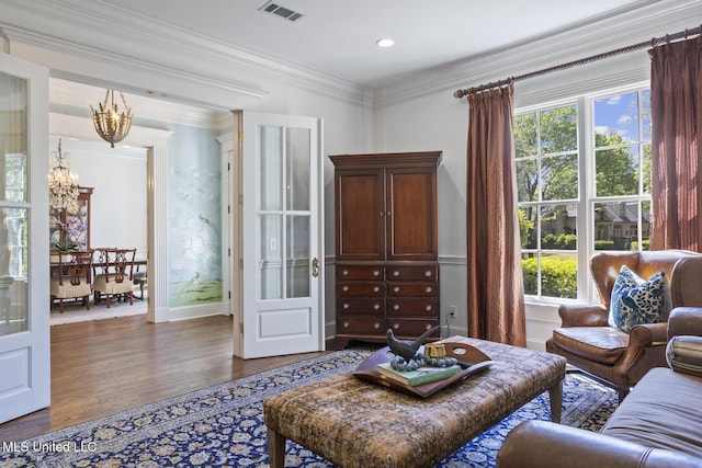 sitting room featuring visible vents, dark wood-type flooring, a chandelier, and a healthy amount of sunlight
