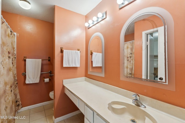 6944 Apona St, Diamondhead, MS 39525 - bathroom with vanity, toilet, tile patterned flooring, baseboards, and curtained shower
