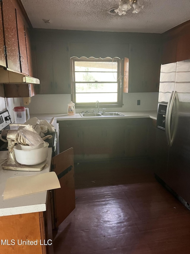 kitchen with sink, range, stainless steel fridge, and a textured ceiling