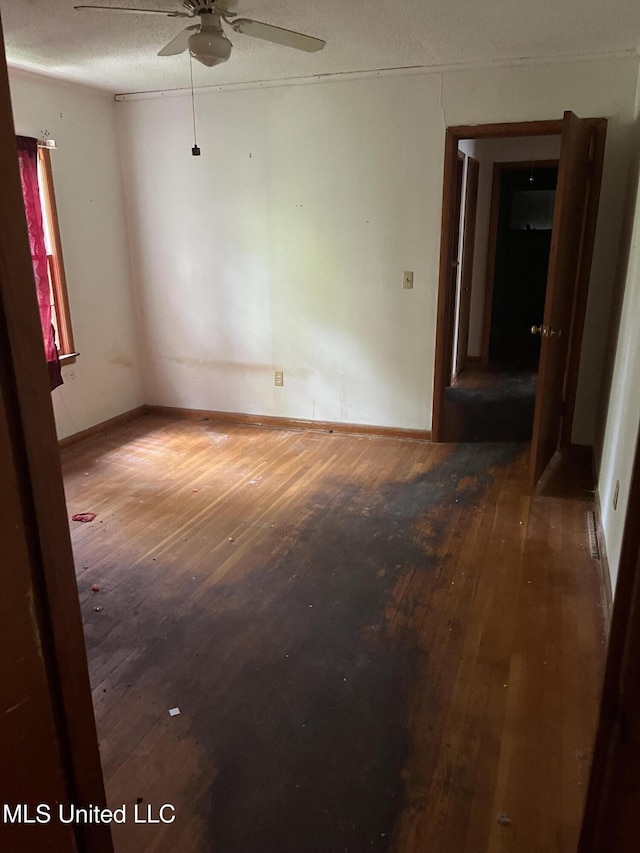 spare room featuring hardwood / wood-style flooring and ceiling fan