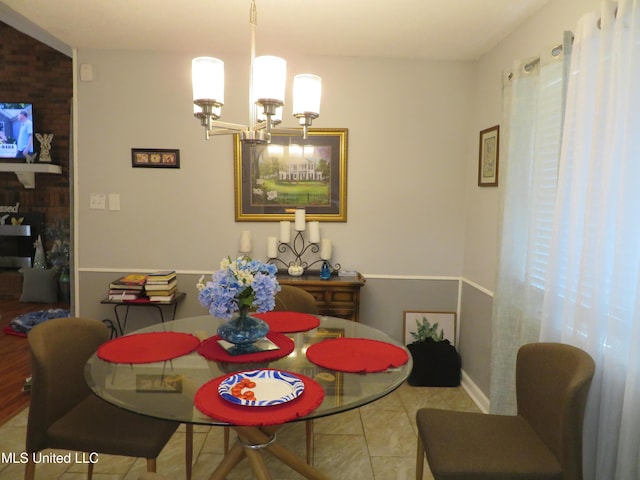 tiled dining room with a notable chandelier