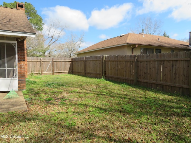 view of yard with a fenced backyard