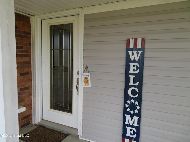 entrance to property with brick siding