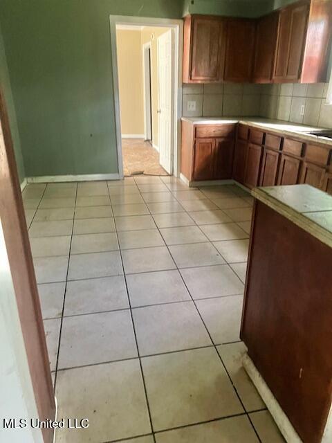 3916 Oakhill Dr, Jackson, MS 39206 - kitchen with decorative backsplash, light countertops, and light tile patterned floors