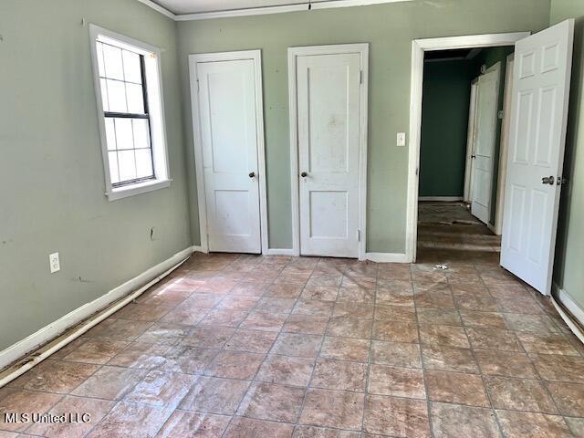 3916 Oakhill Dr, Jackson, MS 39206 - unfurnished bedroom with baseboards and ornamental molding