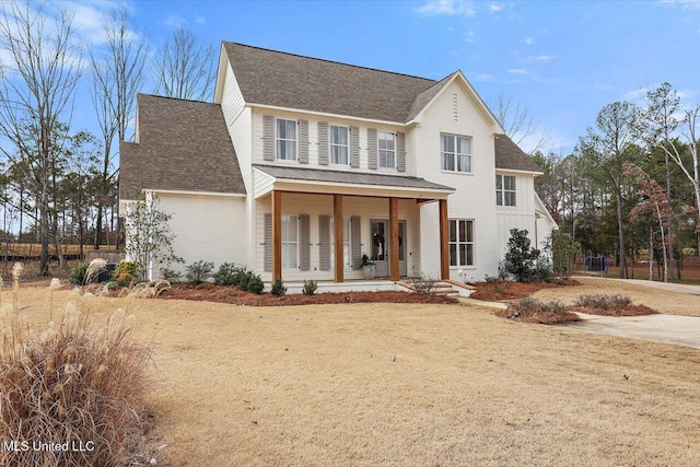 view of front of property with a porch and a front yard