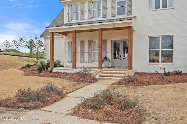 doorway to property featuring covered porch and french doors