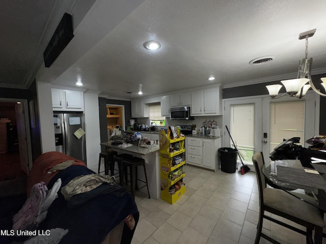 710 Benning Rd, Jackson, MS 39206 - kitchen with appliances with stainless steel finishes, ornamental molding, a breakfast bar area, white cabinetry, and recessed lighting