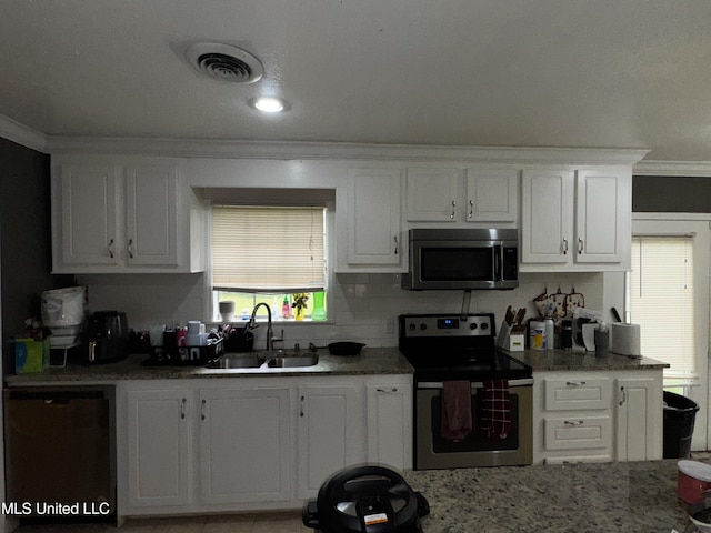 710 Benning Rd, Jackson, MS 39206 - kitchen featuring stainless steel appliances, crown molding, decorative backsplash, white cabinetry, and a sink