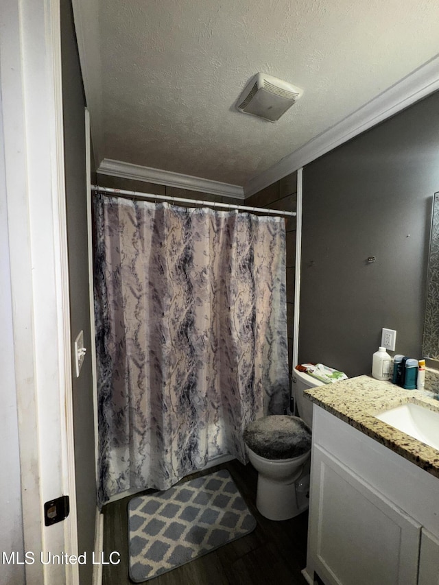 710 Benning Rd, Jackson, MS 39206 - full bath with ornamental molding, vanity, a textured ceiling, toilet, and wood finished floors