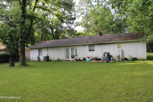 710 Benning Rd, Jackson, MS 39206 - back of property featuring french doors, a yard, roof with shingles, and board and batten siding