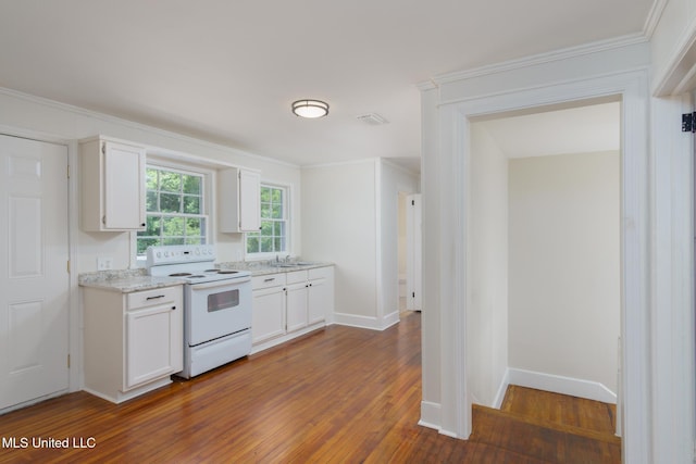 kitchen with dark wood-style floors, visible vents, white cabinets, and white range with electric cooktop