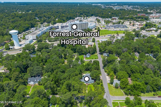 drone / aerial view featuring a forest view