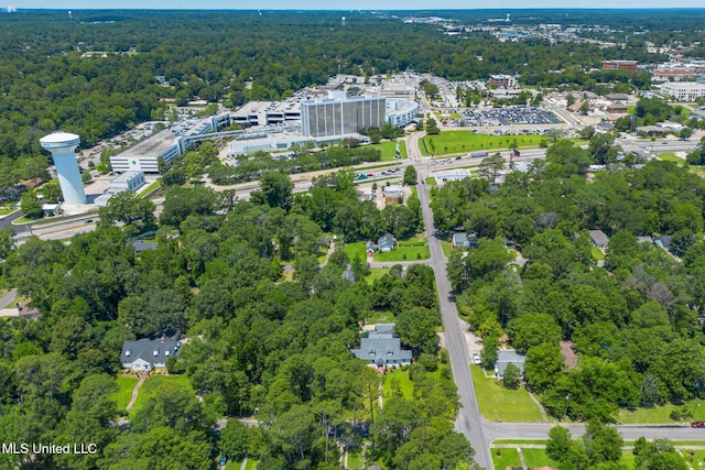 birds eye view of property with a view of trees