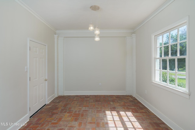 spare room featuring ornamental molding, brick floor, and baseboards