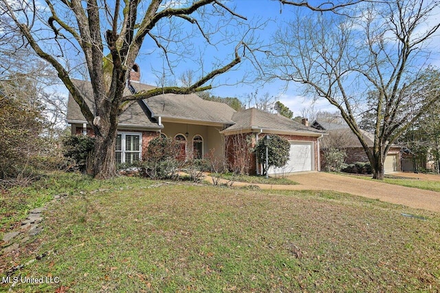 single story home featuring a front yard, a chimney, concrete driveway, and brick siding