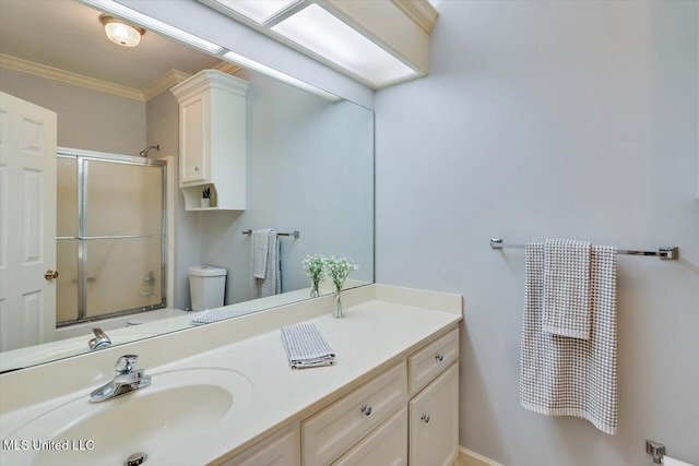 full bath with crown molding, vanity, toilet, and an enclosed shower