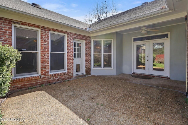 doorway to property with a patio area, ceiling fan, brick siding, and french doors