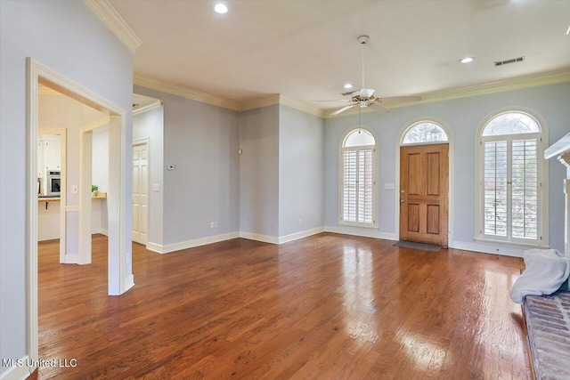 entryway featuring a wealth of natural light, baseboards, ornamental molding, and wood finished floors