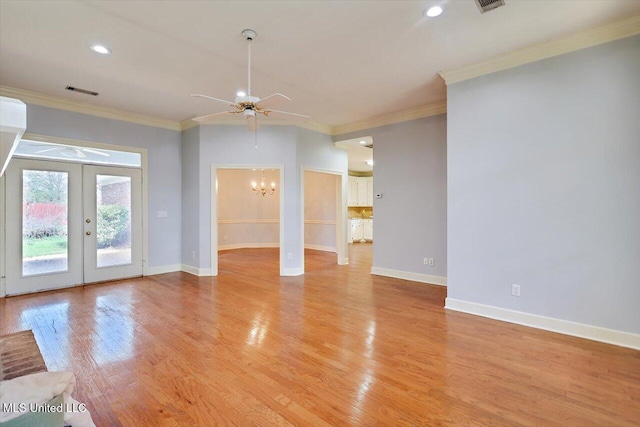 unfurnished living room with visible vents, baseboards, light wood-style floors, french doors, and ornamental molding