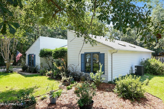 view of property exterior featuring a lawn and central AC unit