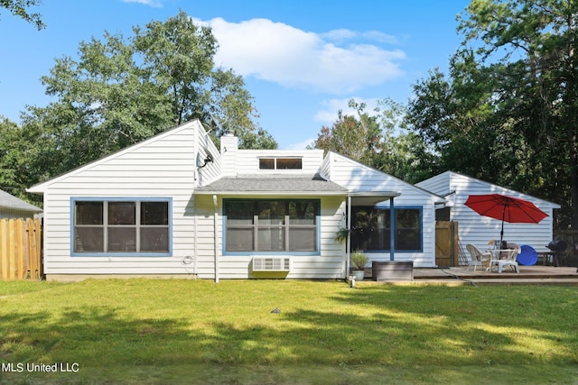 rear view of house with a patio and a lawn