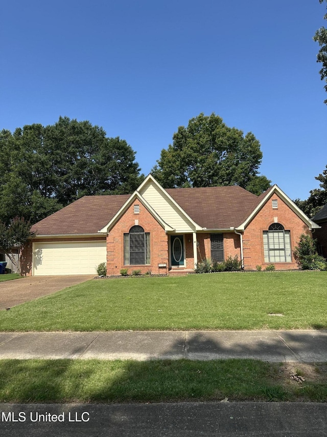 5875 White Ridge Cir W, Olive Branch, MS 38654 - single story home with brick siding, a front yard, driveway, and an attached garage