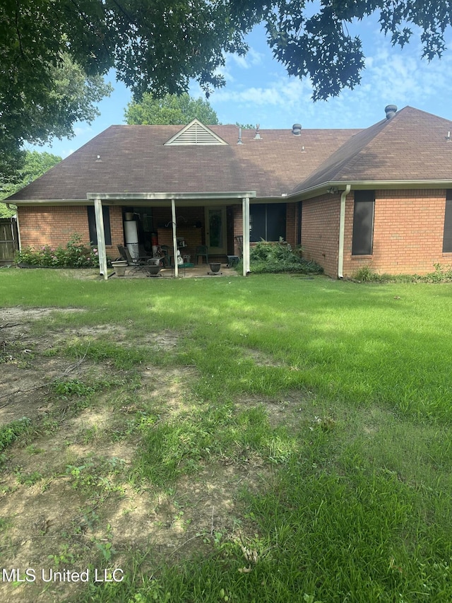 5875 White Ridge Cir W, Olive Branch, MS 38654 - rear view of house with a patio area, brick siding, a lawn, and a shingled roof