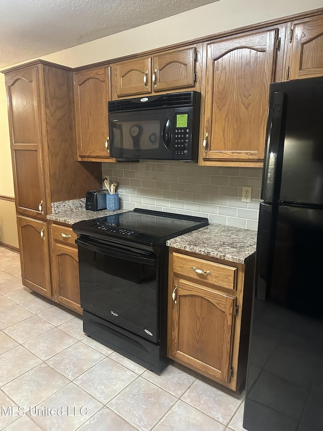 5875 White Ridge Cir W, Olive Branch, MS 38654 - kitchen featuring black appliances, decorative backsplash, light tile patterned floors, brown cabinets, and a textured ceiling